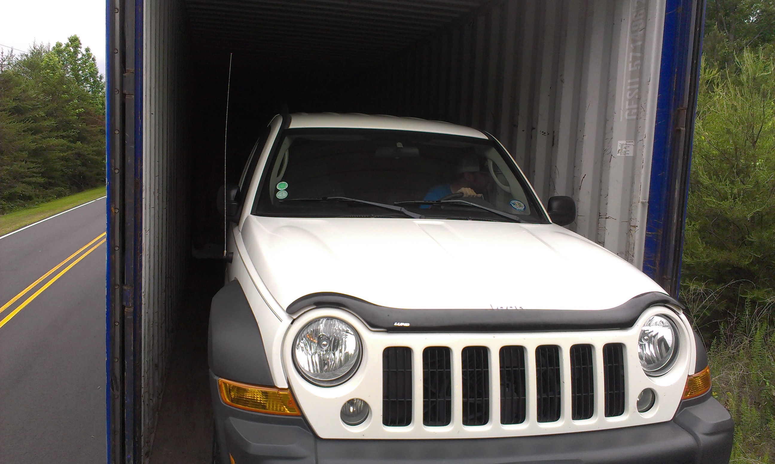 Packing Service, Inc. Loading Car into Shipping Container